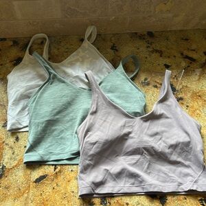 Bundle of 3 Lululemon Align tanks- purple, white camo and green tanks. Size 8.